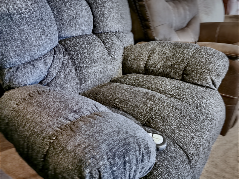 Close-up of the Brosmer Power Lift/Headrest Chair by Best, gray with plush armrests and remote-controlled lumbar support.
