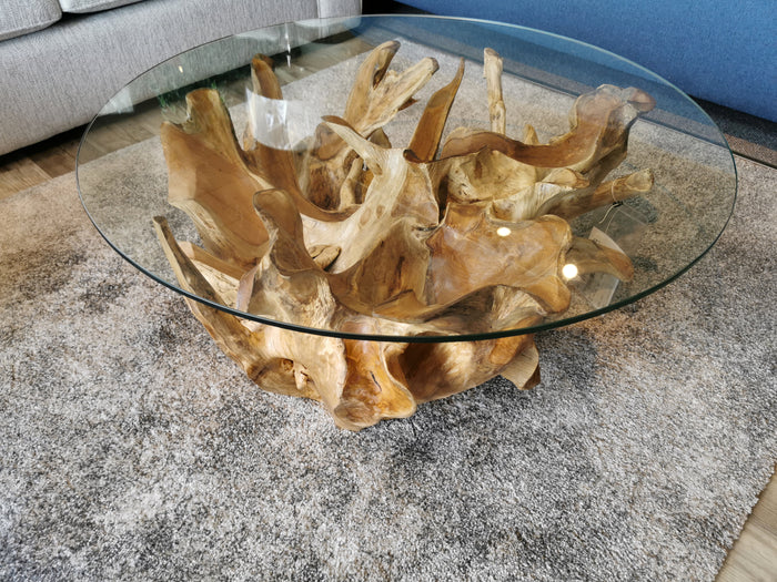 The Heft 5331 31" Natural Root Coffee Table on a textured gray rug creates a cozy cottage vibe in the living room.