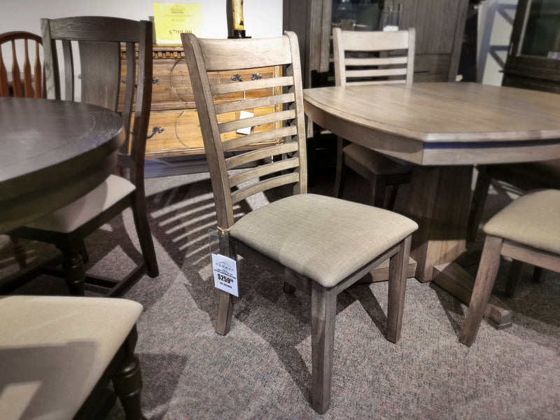 Ventura Side Chair by Winners Only with grey washed finish and cushioned seat is displayed in-store, price tag attached.
